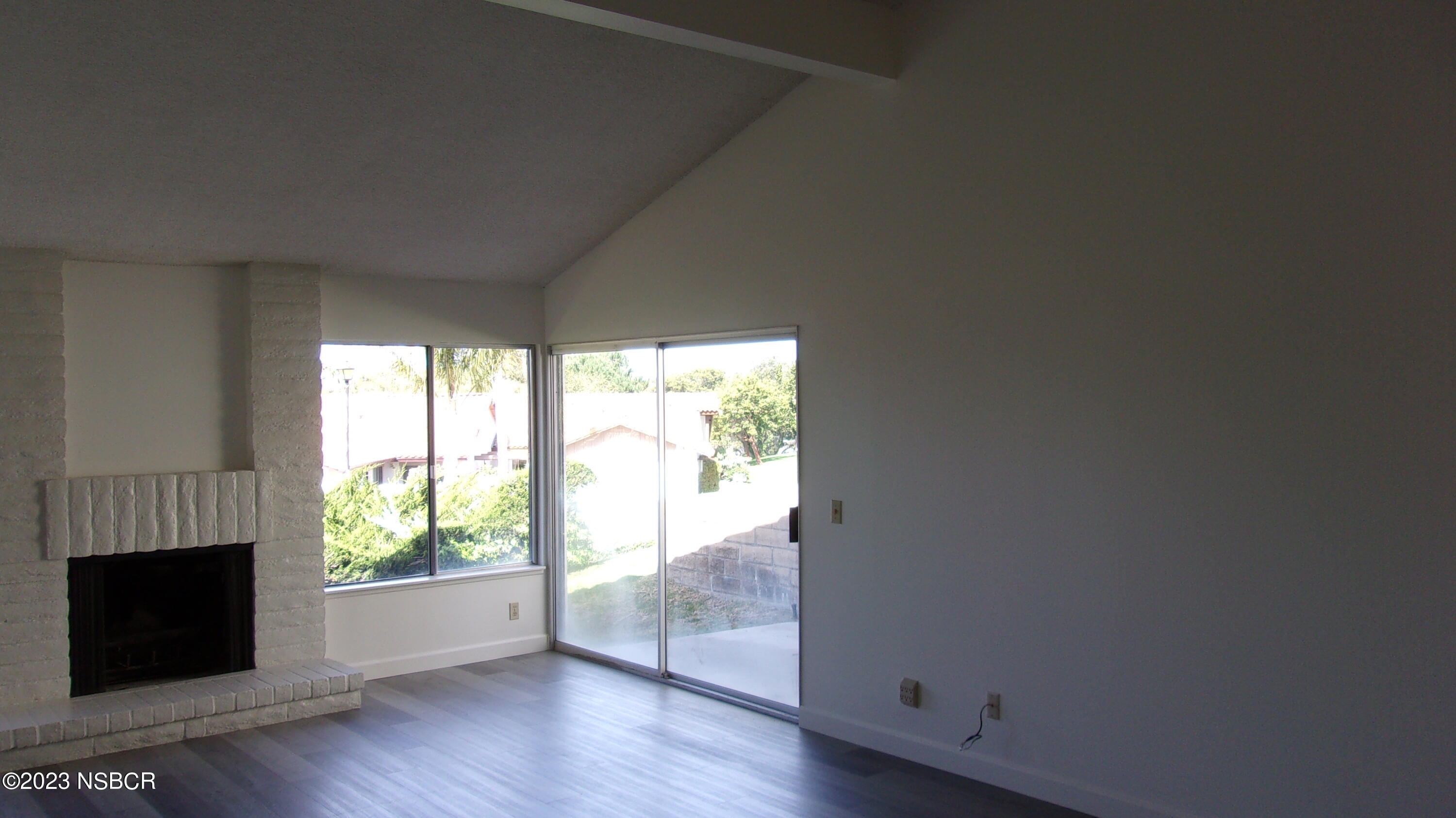 46 Stanford Circle Lompoc, CA 93436 - Photo 10 of 24 a view of an empty room with wooden floor and a window