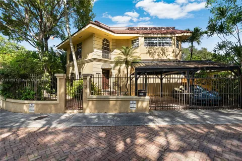 a front view of house with a garden