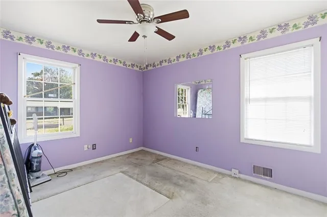 a view of a livingroom with furniture and a window