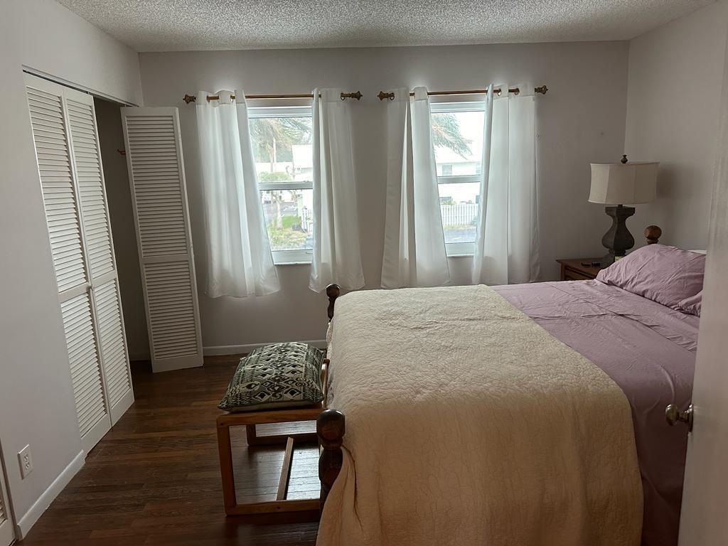 9417 South Ocean Drive, Unit 37 Jensen Beach, FL 34957 - Photo 11 of 18 a bedroom with a bed and a window