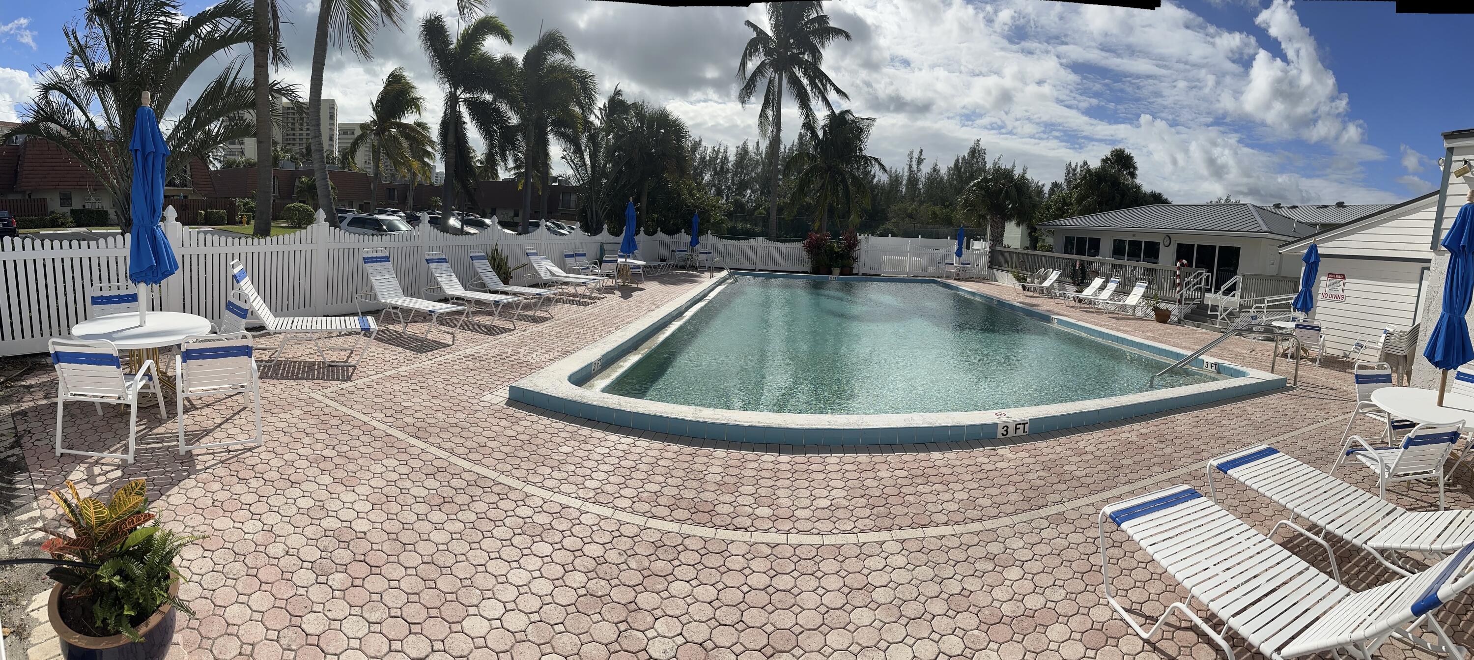 9417 South Ocean Drive, Unit 37 Jensen Beach, FL 34957 - Photo 16 of 18 a view of swimming pool with outdoor seating and plants