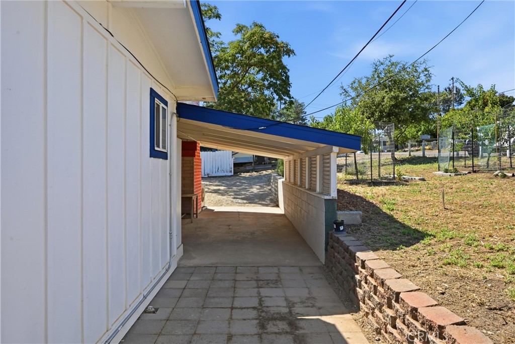 13701 Arrowhead Road Clearlake, CA 95422 - Photo 14 of 21 Looking back at the carport from the pavers, fruit trees in the front yard on the right.