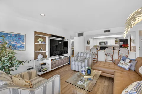 a spacious bedroom with a bed and a flat screen tv