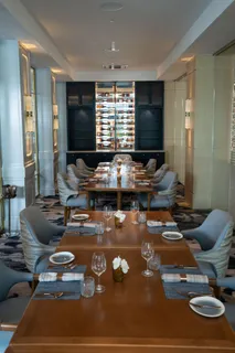 a living room with furniture a chandelier and a large window