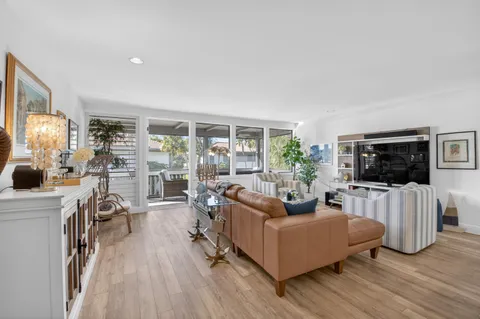 a bedroom with furniture wooden floor and a potted plant