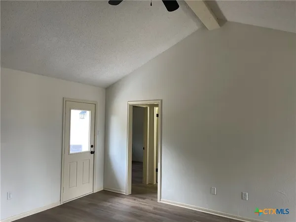 an empty room with wooden floor and closet