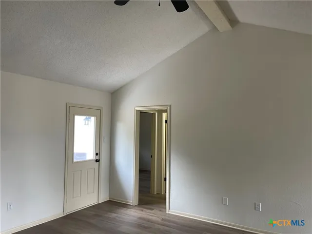 an empty room with wooden floor and closet