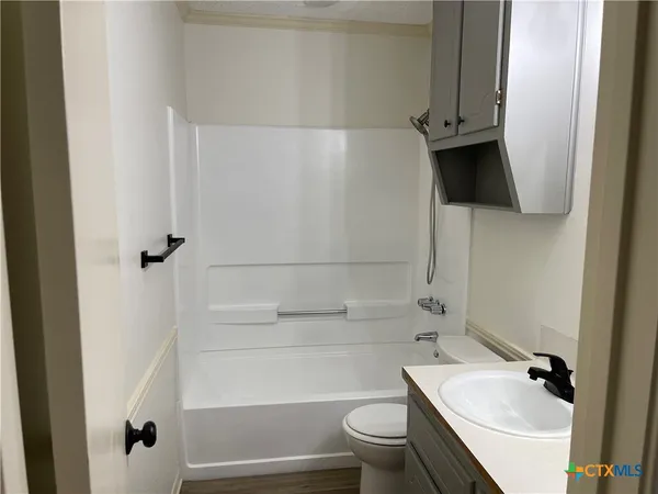 a bathroom with a toilet a sink and bathtub