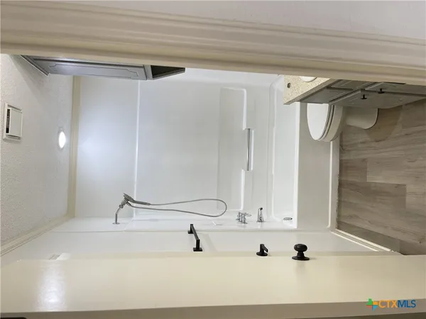 a bathroom with a tub sink and mirror