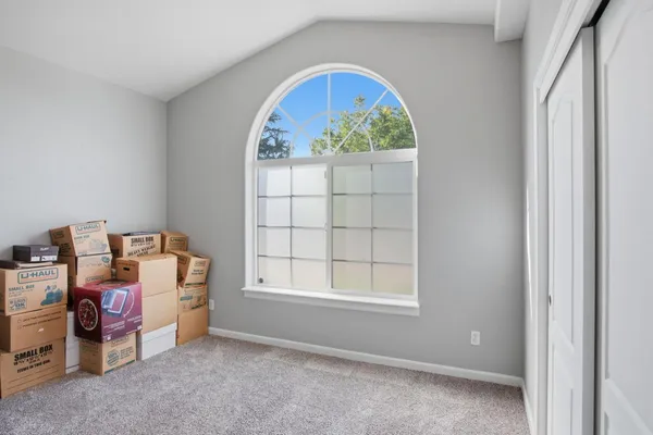 a bedroom with a bed and window