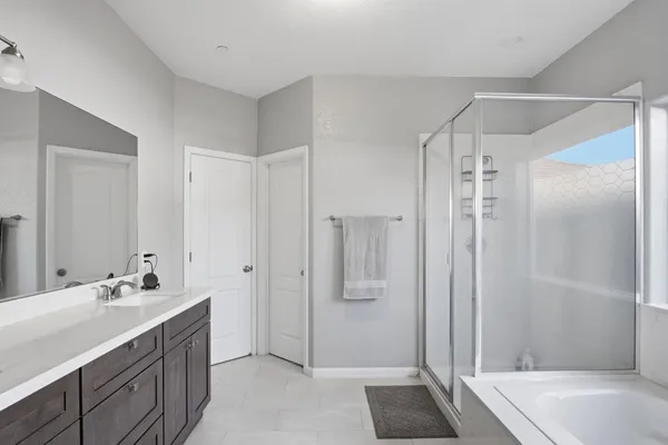 a bathroom with a double vanity sink and a mirror