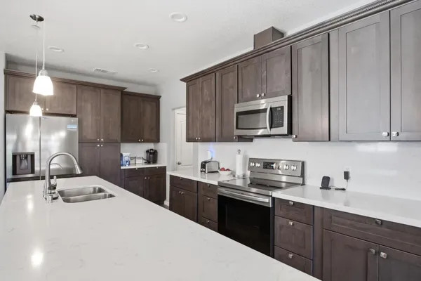 a kitchen with a sink cabinets and stainless steel appliances