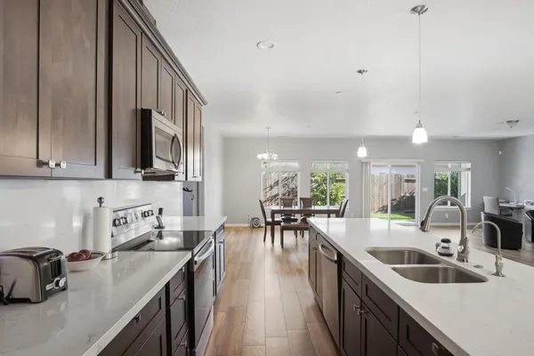 a kitchen with counter top space a sink appliances and cabinets