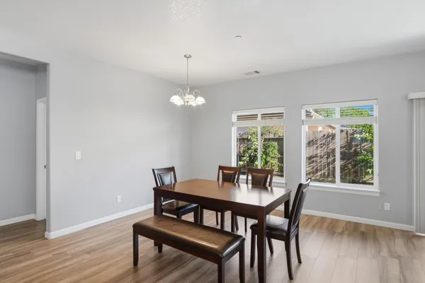 a view of a dining room with furniture window and wooden floor