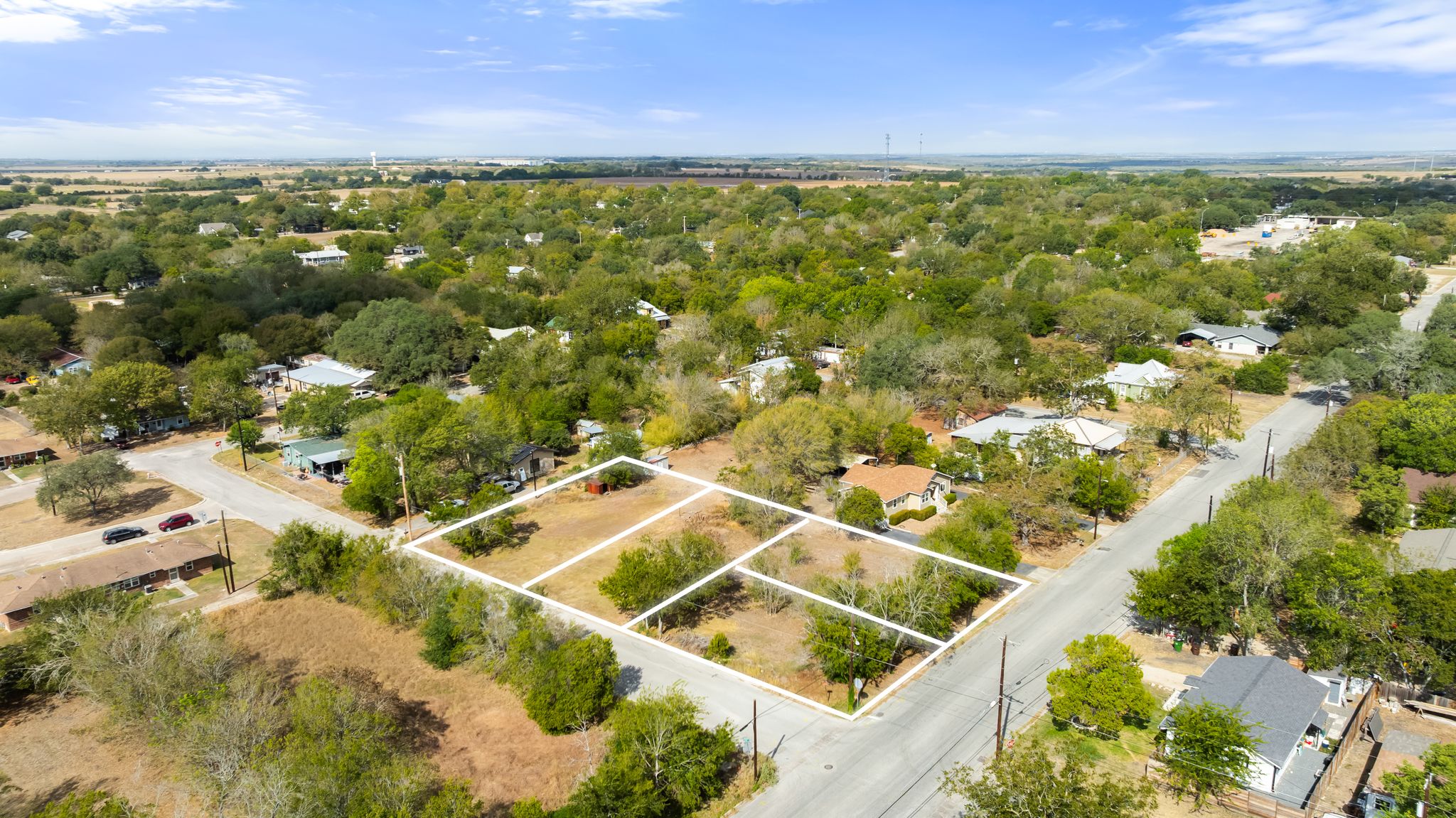905 North Blanco Street Lockhart, TX 78644 - Photo 4 of 6 an aerial view of residential houses with outdoor space and trees