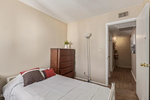 a bedroom with a bed and a dresser