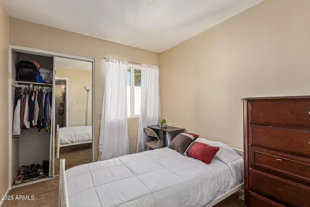 a bedroom with a bed and a walk in closet