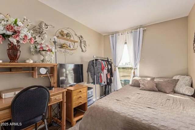 a bedroom with a bed and a chair