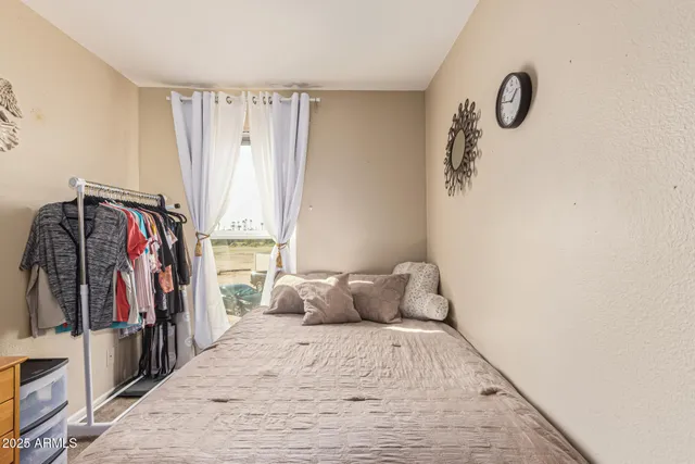 a bedroom with a bed and a window