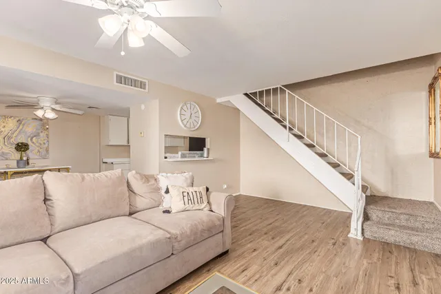 a living room with furniture and wooden floor