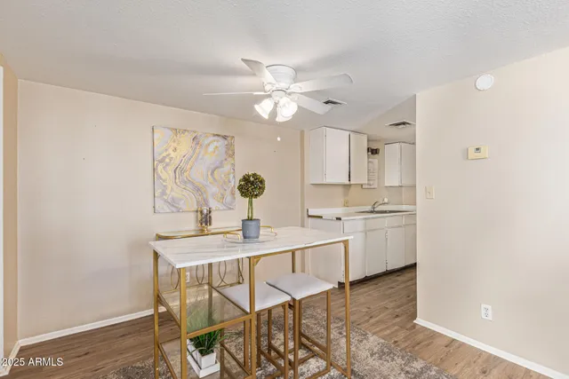 a kitchen with stainless steel appliances a sink cabinets and wooden floor