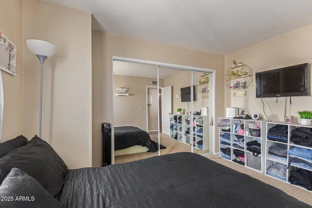a bedroom with furniture and a flat screen tv