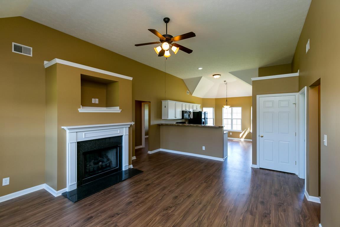 4829 Alsup Mill Road Lascassas, TN 37085 - Photo 3 of 19 a view of a livingroom with a fireplace a ceiling fan and wooden floor
