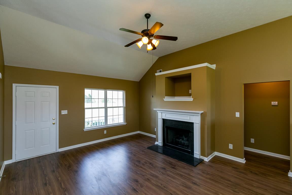 4829 Alsup Mill Road Lascassas, TN 37085 - Photo 4 of 19 a view of a livingroom with a fireplace wooden floor and a window