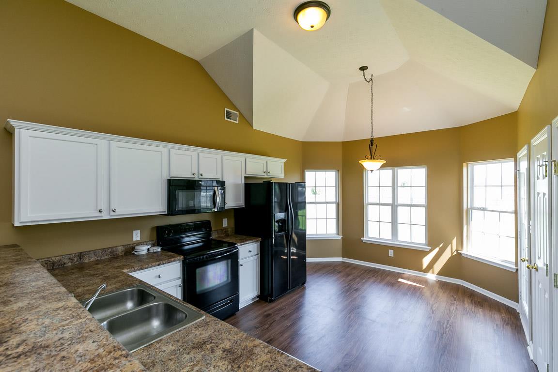 4829 Alsup Mill Road Lascassas, TN 37085 - Photo 6 of 19 a kitchen with stainless steel appliances granite countertop a stove a sink and a microwave
