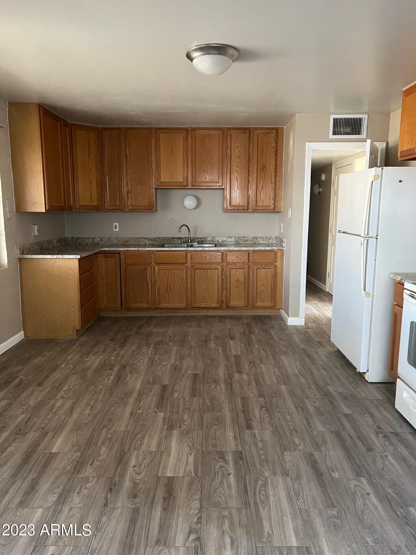 8638 North 8th Street Phoenix, AZ 85020 - Photo 2 of 12 a large kitchen with a lot of cabinets and wooden floor