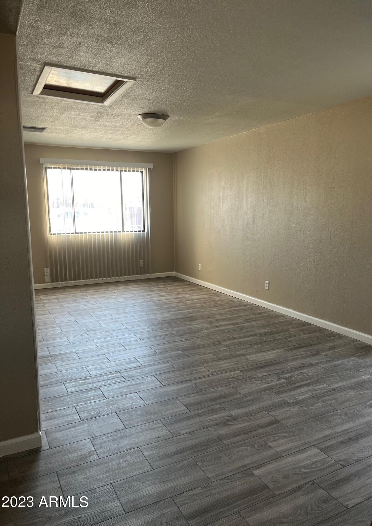 8638 North 8th Street Phoenix, AZ 85020 - Photo 3 of 12 a view of empty room with wooden floor and fan