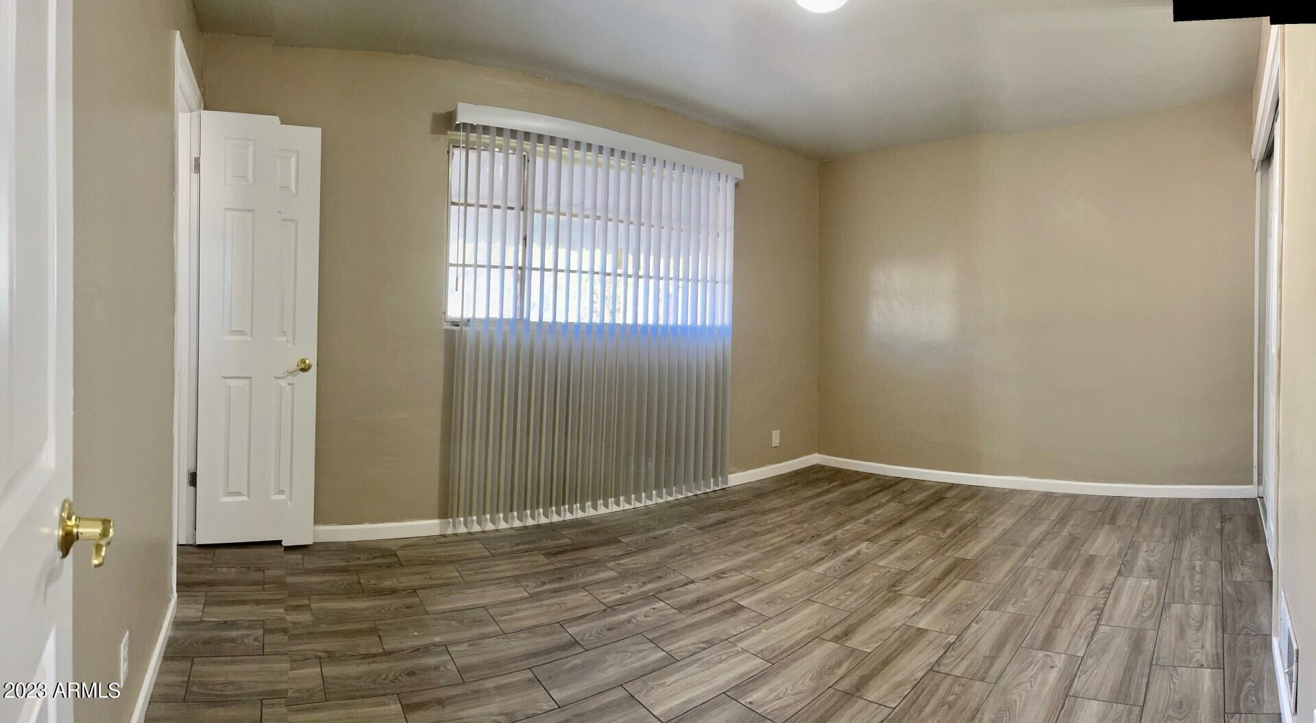 8638 North 8th Street Phoenix, AZ 85020 - Photo 5 of 12 an empty room with wooden floor and windows