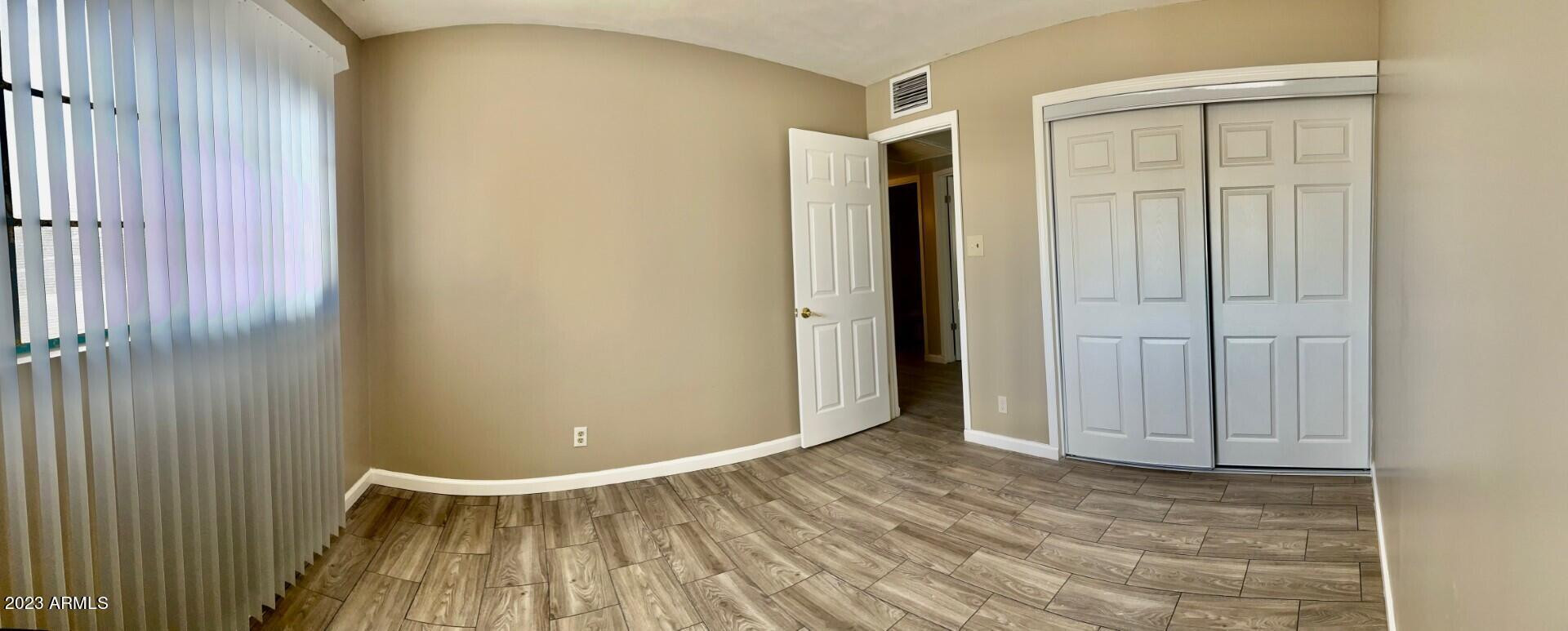 8638 North 8th Street Phoenix, AZ 85020 - Photo 6 of 12 an empty room with wooden floor and closet