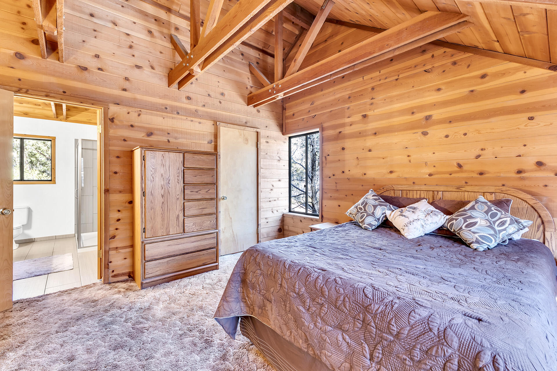 53340 Idyllbrook Drive Idyllwild, CA 92549 - Photo 47 of 68 a bedroom with a bed and dresser with mirror