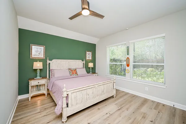 a bedroom with a bed and wooden floor