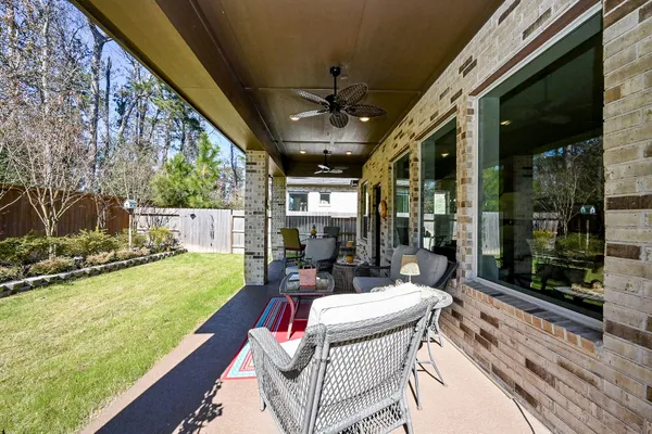 a view of backyard with small cabin and wooden fence