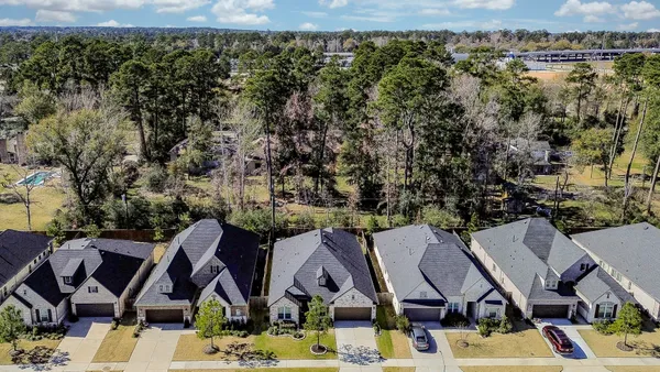 an aerial view of residential houses with outdoor space