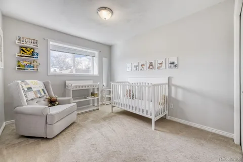 a spacious bedroom with a bed and a couch