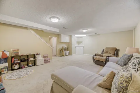 a living room with furniture and kitchen view