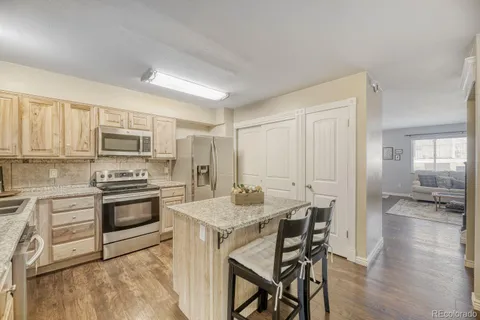 a kitchen with a stove a sink and a refrigerator