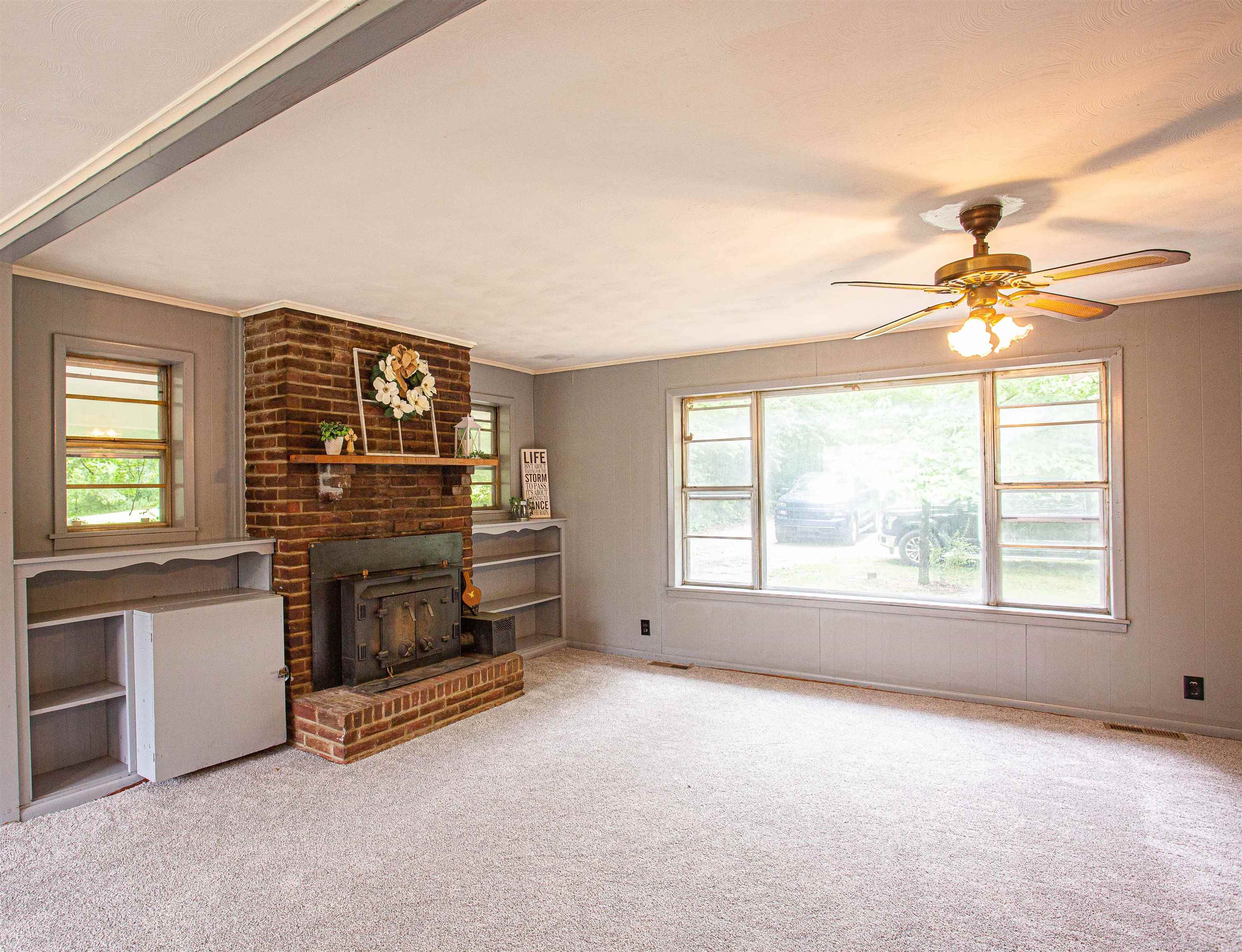 6223 Conner Whitefield Road Ripley, TN 38063 - Photo 4 of 35 an empty room with furniture and a fireplace