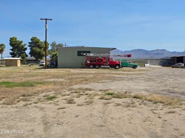 a view of a house with a road and a car parked