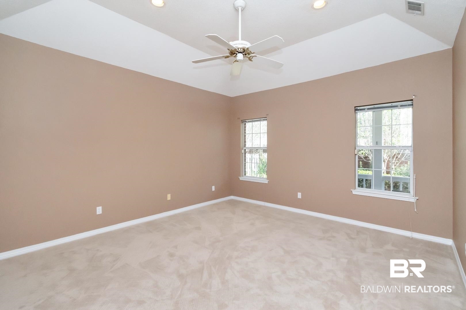 6117 Lennox Place Mobile, AL 36693 - Photo 26 of 39 Empty room featuring visible vents, baseboards, a wealth of natural light, and light colored carpet