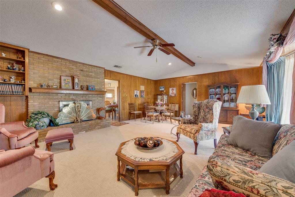 830 Mt Zion Road Midlothian, TX 76065 - Photo 10 of 36 Living room with vaulted ceilings, fireplace, paneling and room for formal dining