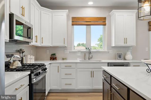 a kitchen with a sink stove top oven and cabinets