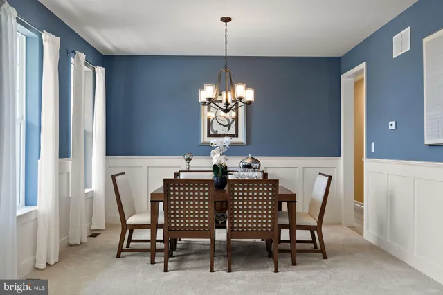 a view of a dining room with furniture and window