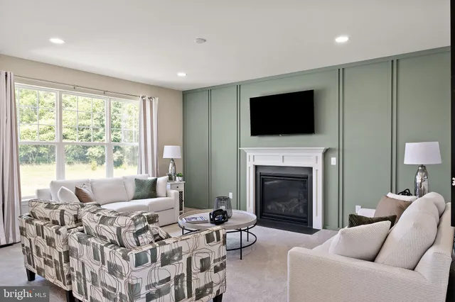 a front view of a house with a yard and trees