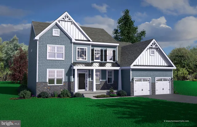 a front view of a house with a garden and yard