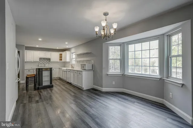 a view of a kitchen with a sink a refrigerator and window