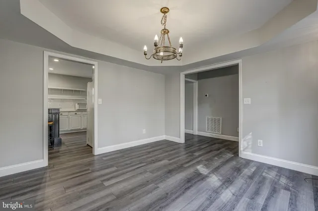 a view of staircase with wooden floor and white walls